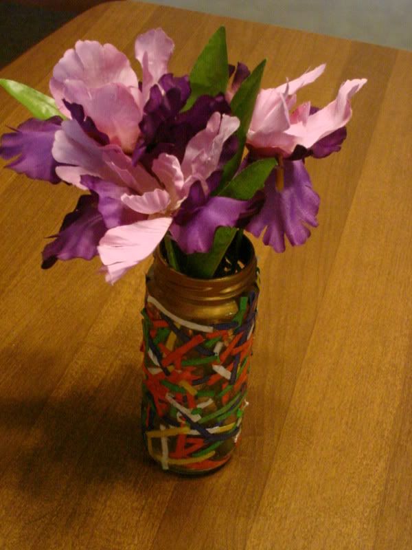 From Samantha - silk Irises in an olive jar that she decorated.